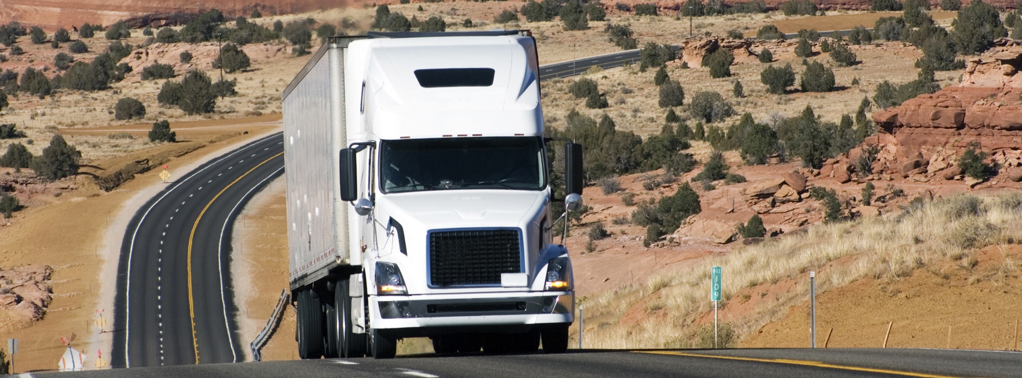 Semi-truck driving down Arizona highway, truck accident lawyer
