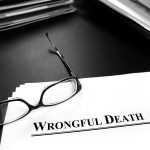 A piece of paper that says “WRONGFUL DEATH” with a pair of reading glasses on top in Mesa.